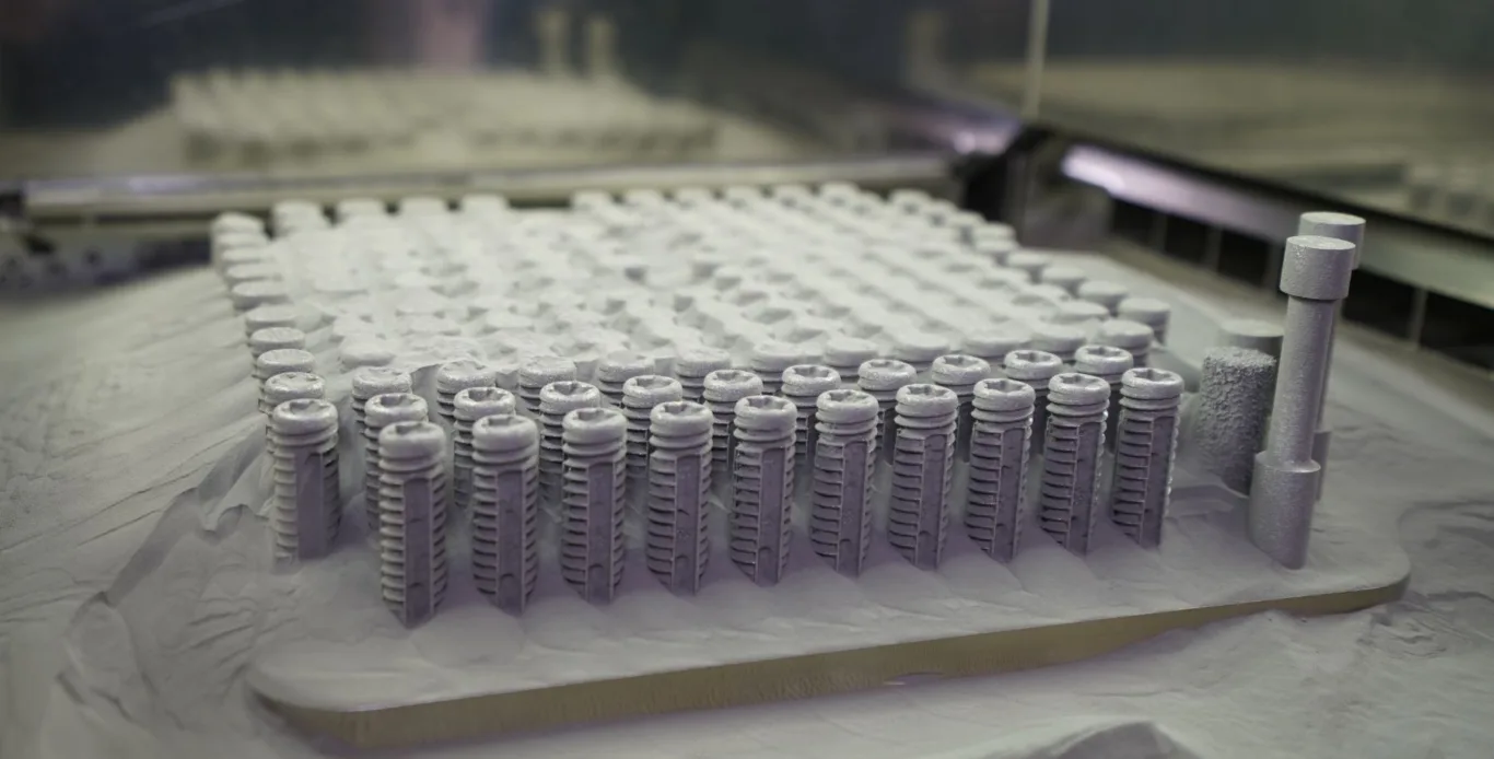 SI fixation screw configurations on an additive manufacturing build plate at Croom Medical